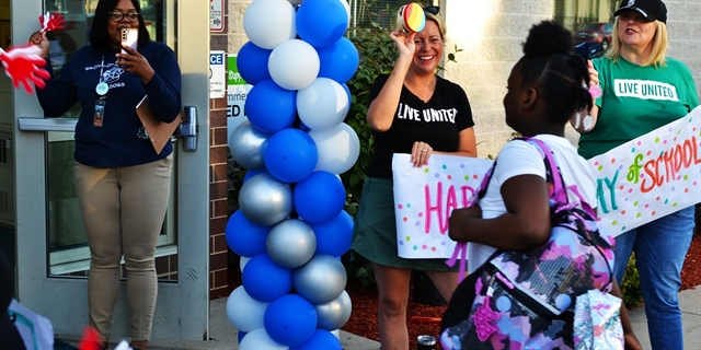 A student enters school for the first day of school at Browning