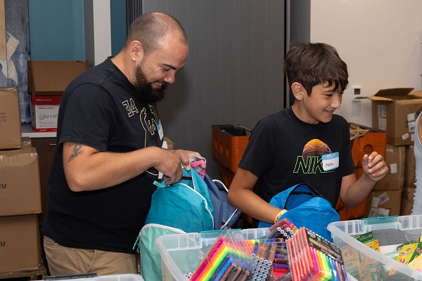 Volunteers pack backpacks for United Way's Backpack Coaltion