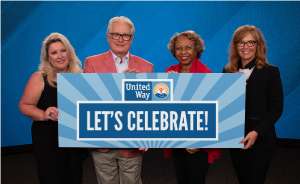 Co-Chairs holding Let's Celebrate sign