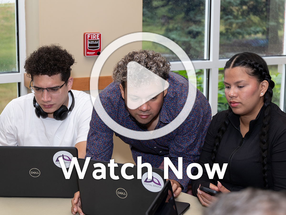 People working on computers with overlay play button