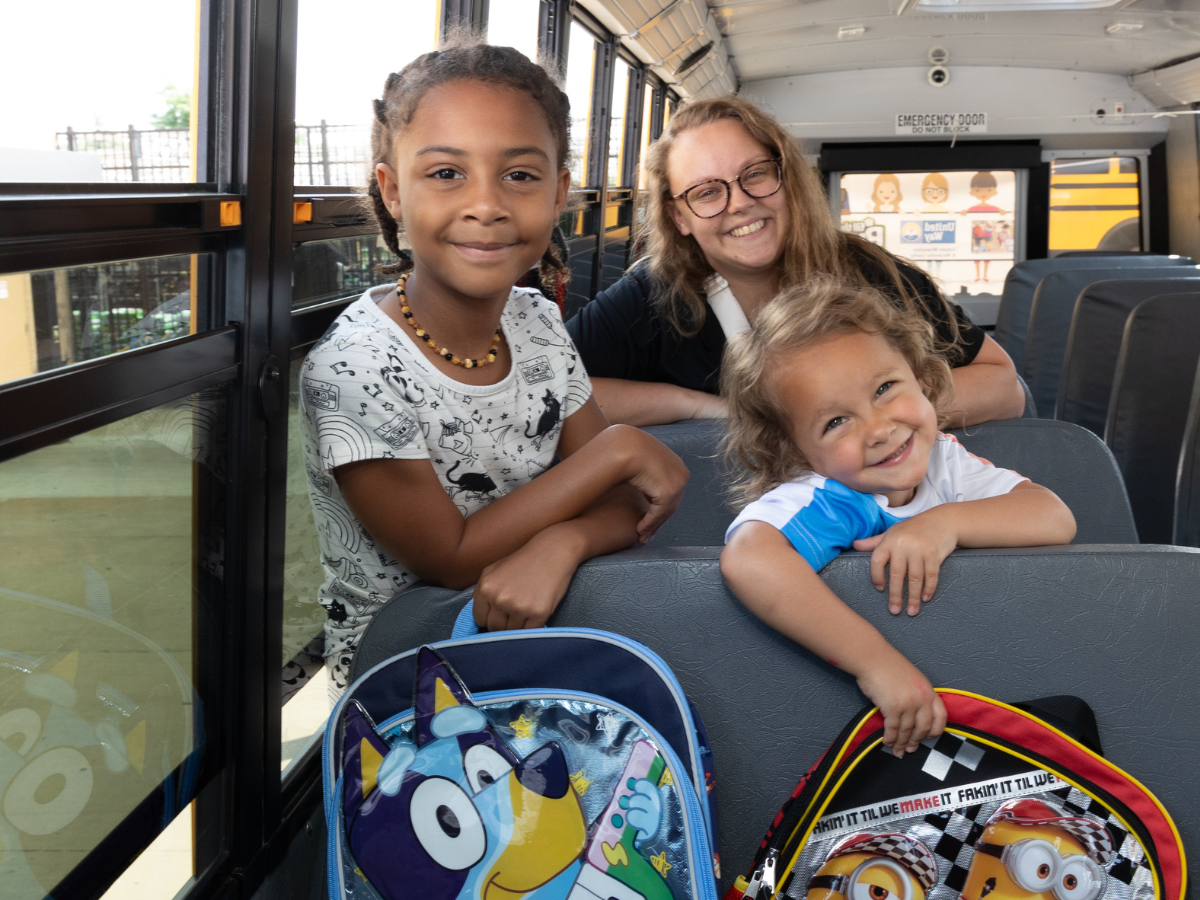 Image of kids and mother in school bus