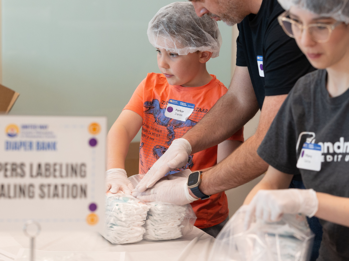 Image of family packing diapers at event