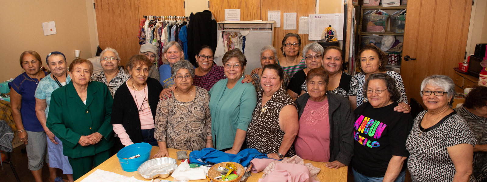 People behind table with clothes