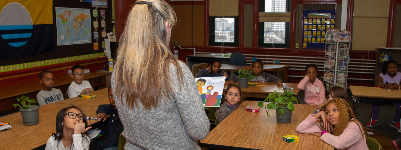 teacher reading to classroom of students
