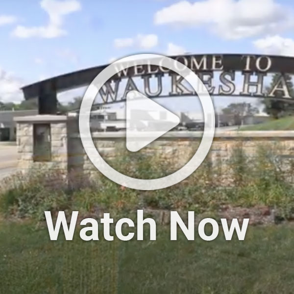 photo of Waukesha sign with a video play button overlay