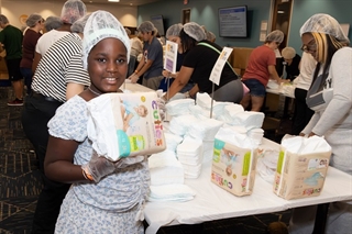 A young volunteer at a diaper repack event