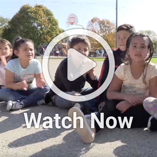 image ofgroup of children with a play overlay button