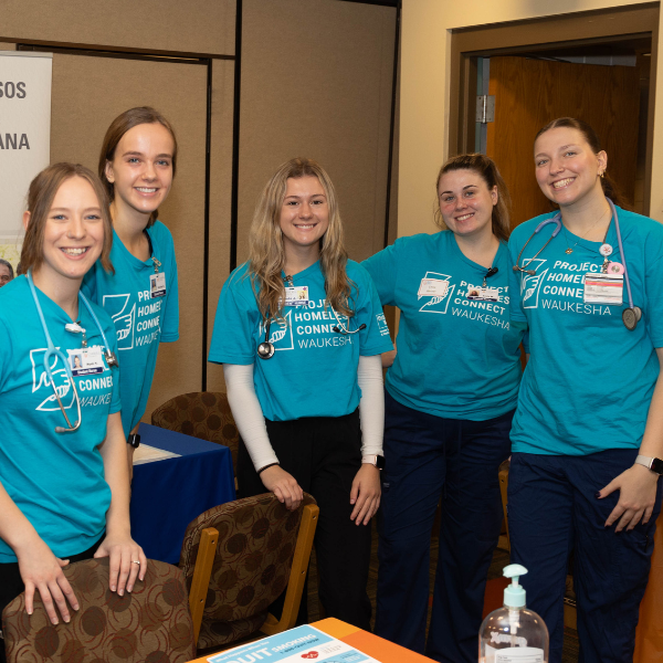 Volunteers in Blue Shirts at Project Homeless Connect in Waukesha