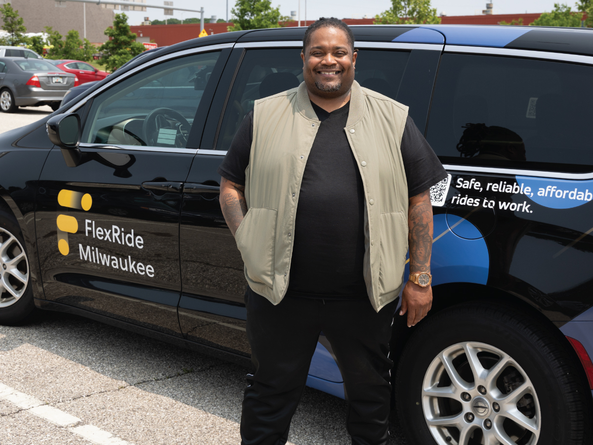 Zachery in front of a FlexRide van