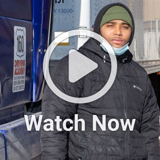 image of a man in front of a truck with a play overlay button