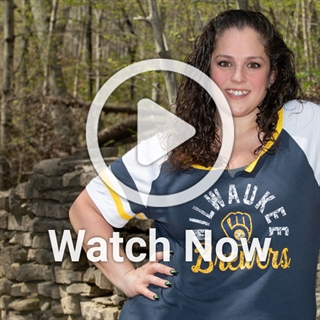 image of woman with nature in background with a play overlay button