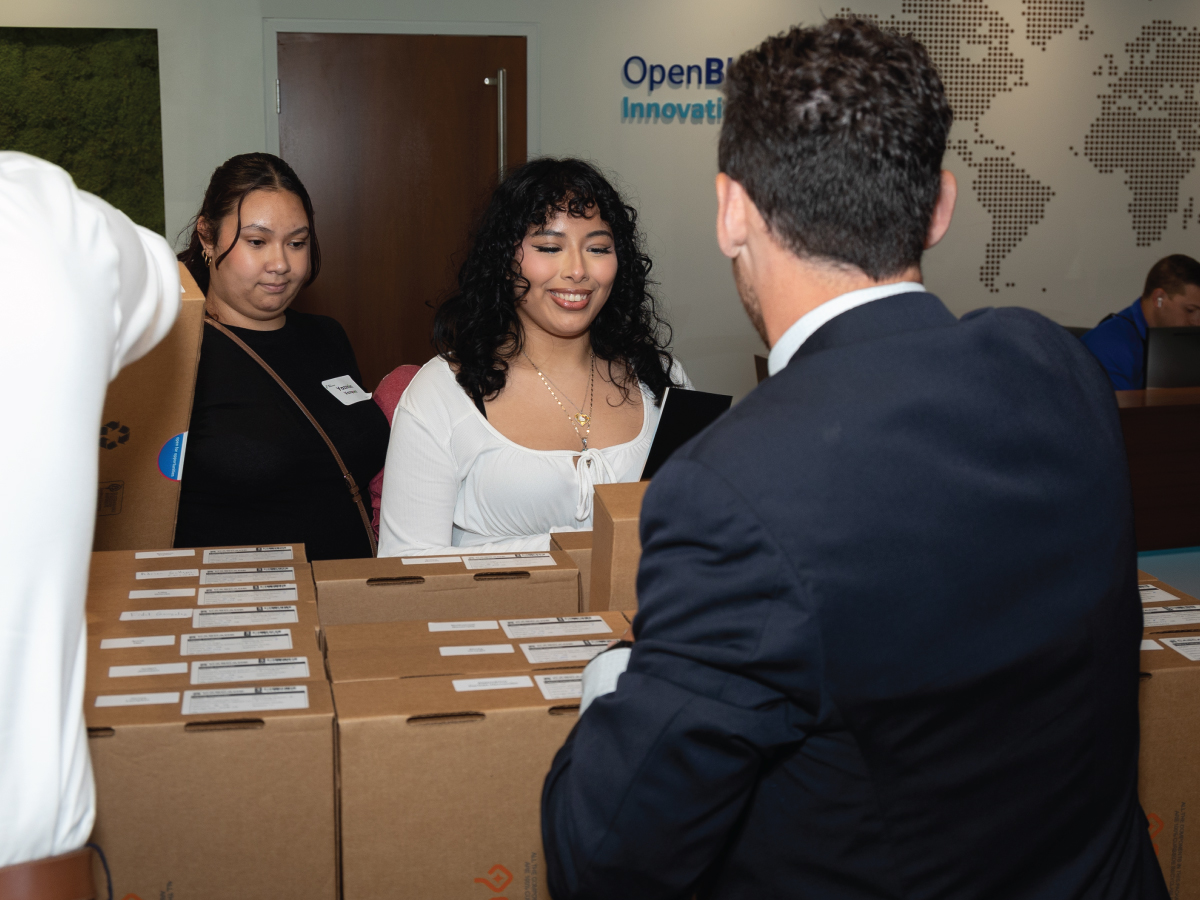 Students receive laptops at an All-In Milwaukee event