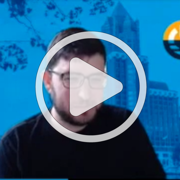 Screenshot of video with play button to signify if you click you'll view a video.