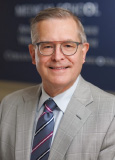headshot of Dr. John Raymond Sr.